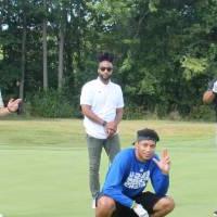 four lakers posing together on the golf course